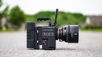 black camera on gray concrete floor representing video production and animation capabilities