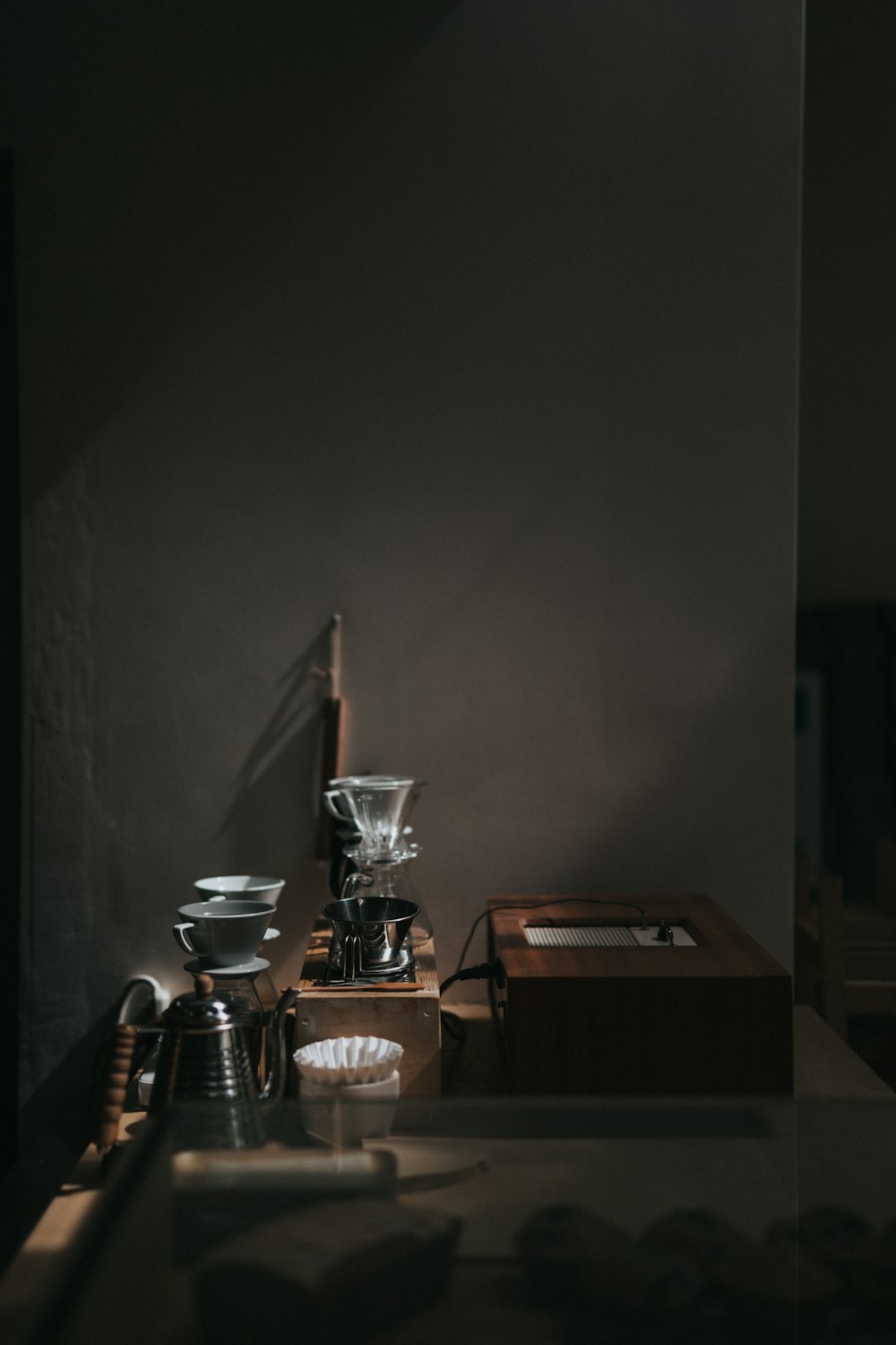 stainless steel and black coffee maker on brown wooden table