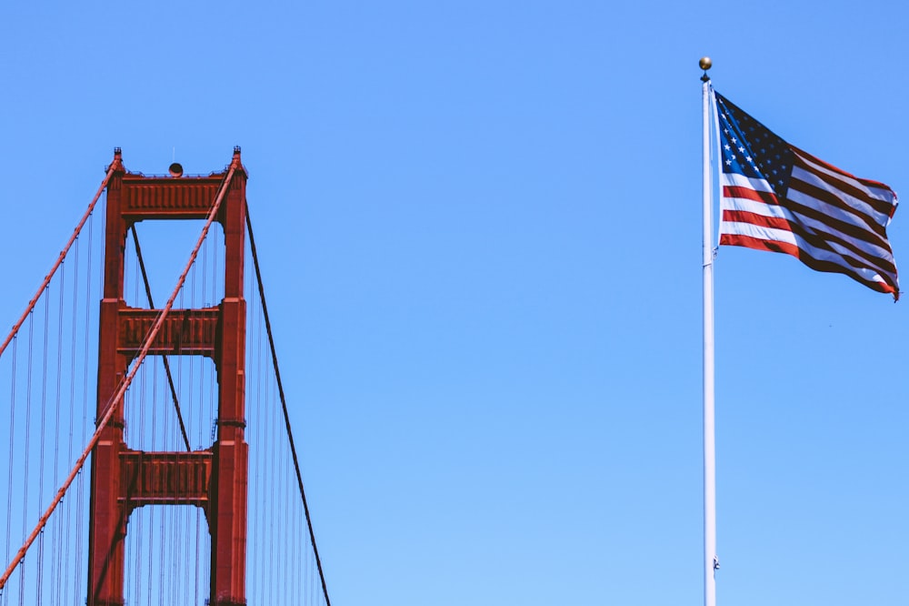 us a flag on flag pole during daytime