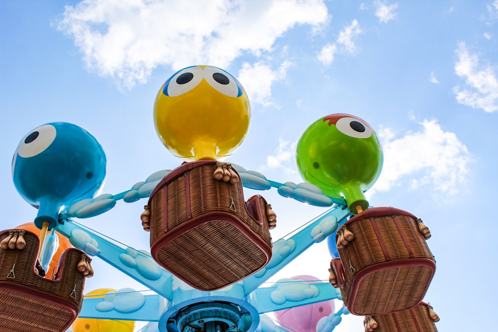 yellow red blue and green balloons under blue sky during daytime