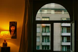 Close-up of a Bollywood icon metal poster reflecting soft natural light in a cozy bedroom corner.