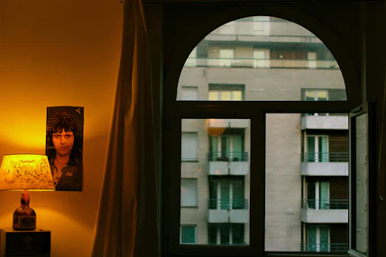 A friendly landlord showing a tenant around a cozy rental room.