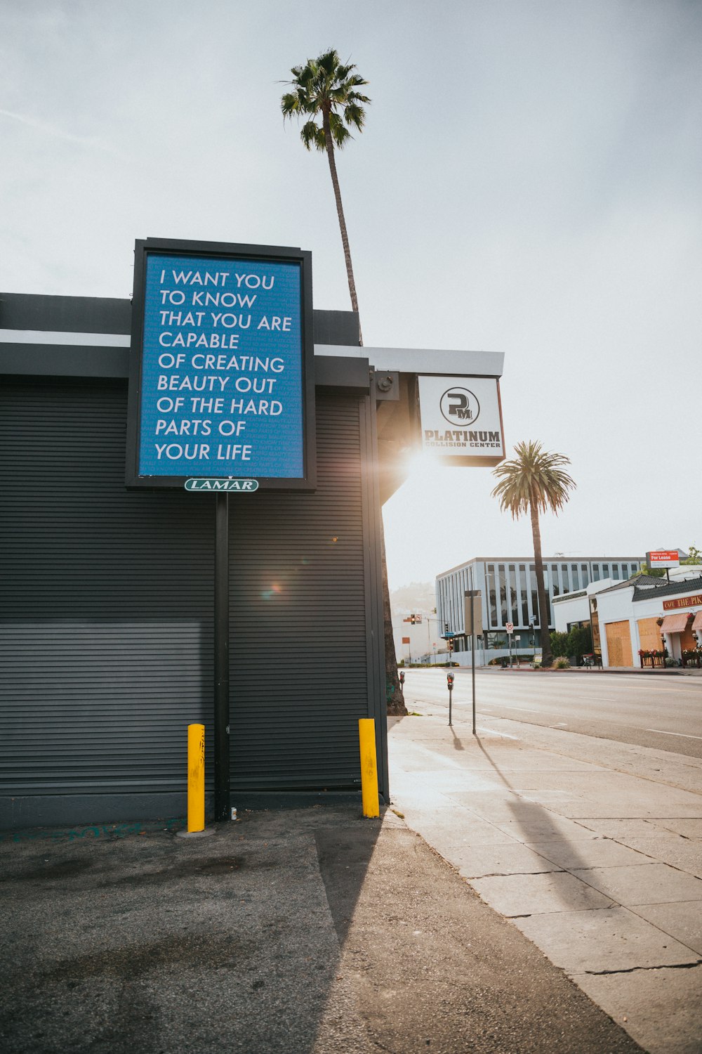 blue and white signage on gray steel post