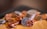 A close-up of vintage coins arranged neatly on a wooden table.