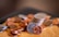 A collection of various coin rings displayed on a wooden surface with soft lighting.