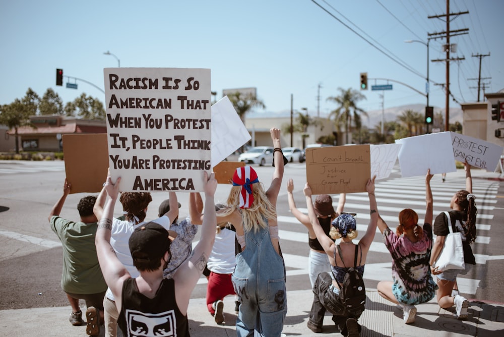 people holding white printer paper during daytime