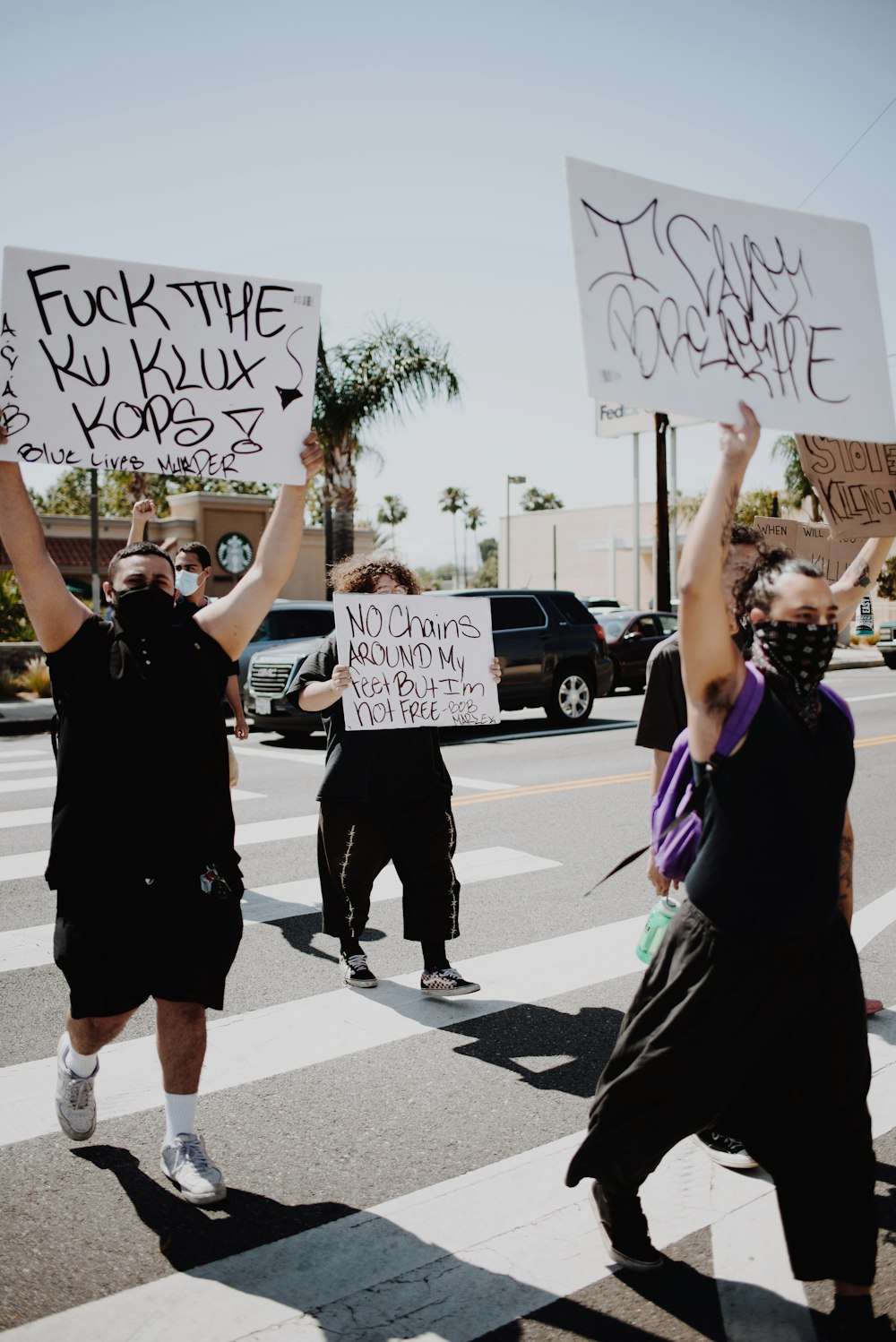 man and woman holding white and black signage