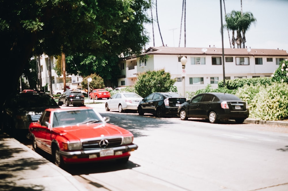 red chevrolet camaro parked on street during daytime