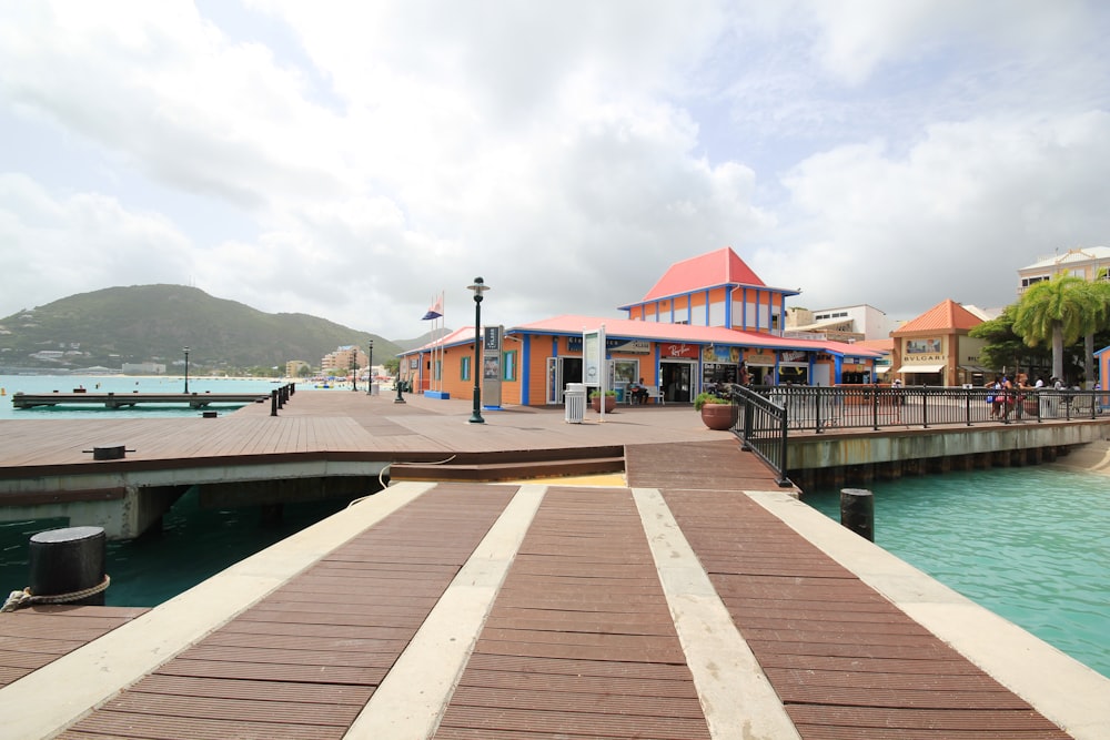 brown wooden dock near body of water during daytime