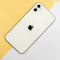 A white smartphone with a dual camera system on a yellow and white background