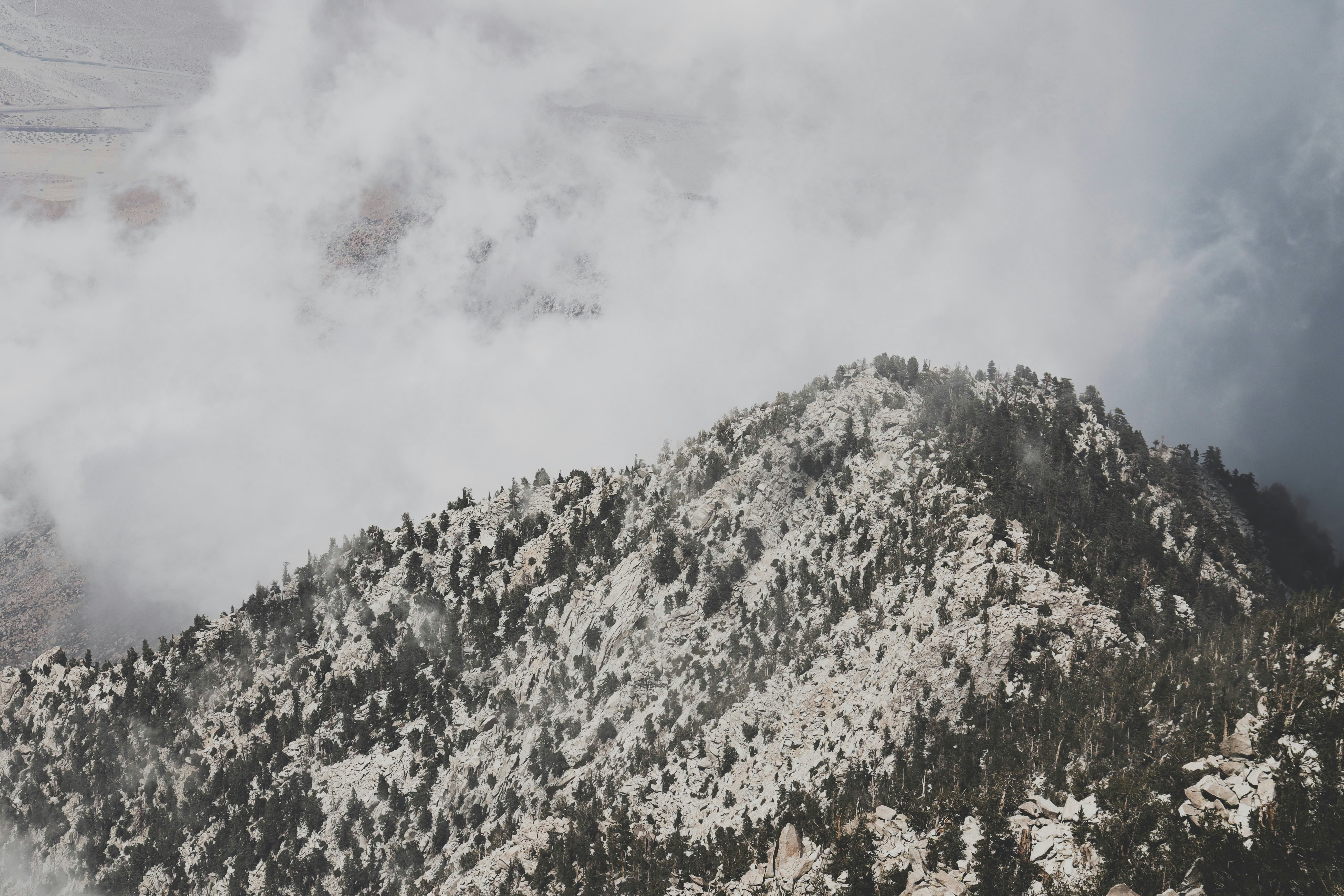 green and brown mountain under white clouds during daytime