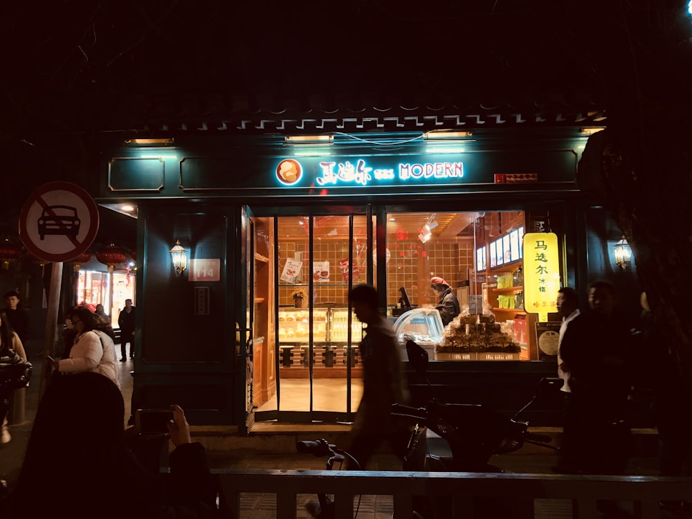 people sitting on chair near store during night time