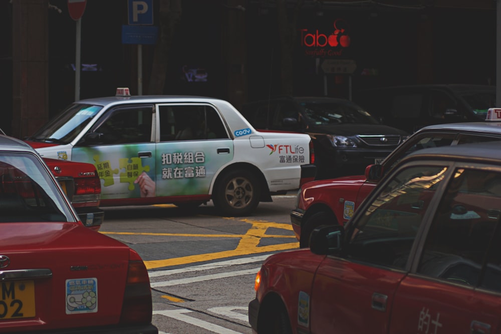 red and white taxi cab on the street during daytime