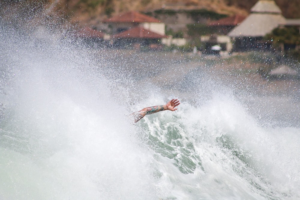person surfing on water wave during daytime