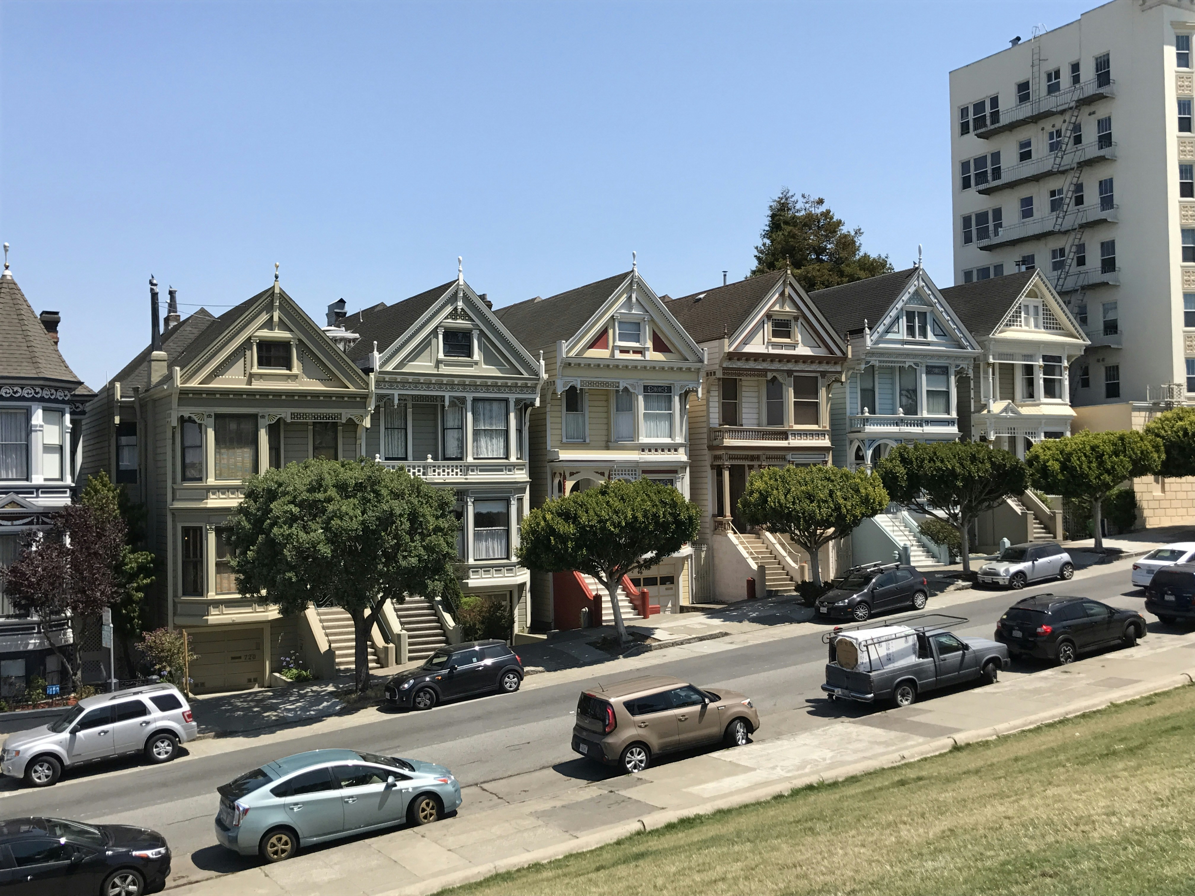 cars parked in front of building during daytime