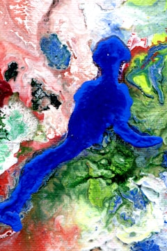 An abstract painting featuring a prominent blue silhouette resembling a human figure set against a dynamic and swirling background of vibrant colors. The backdrop showcases a combination of greens, reds, and whites, with intricate textures give a sense of movement and fluidity.