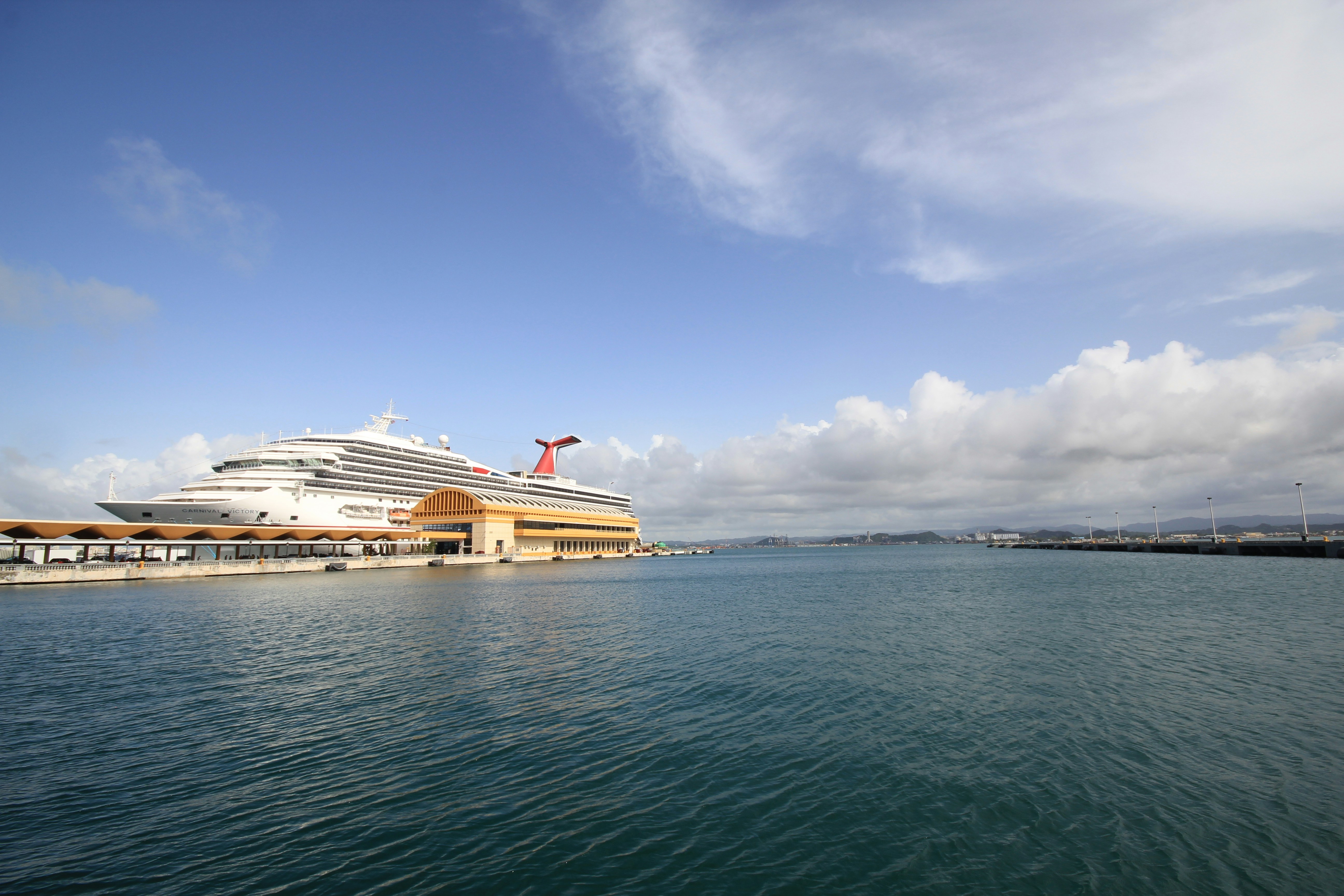 White cruise ship on sea under blue sky during daytime