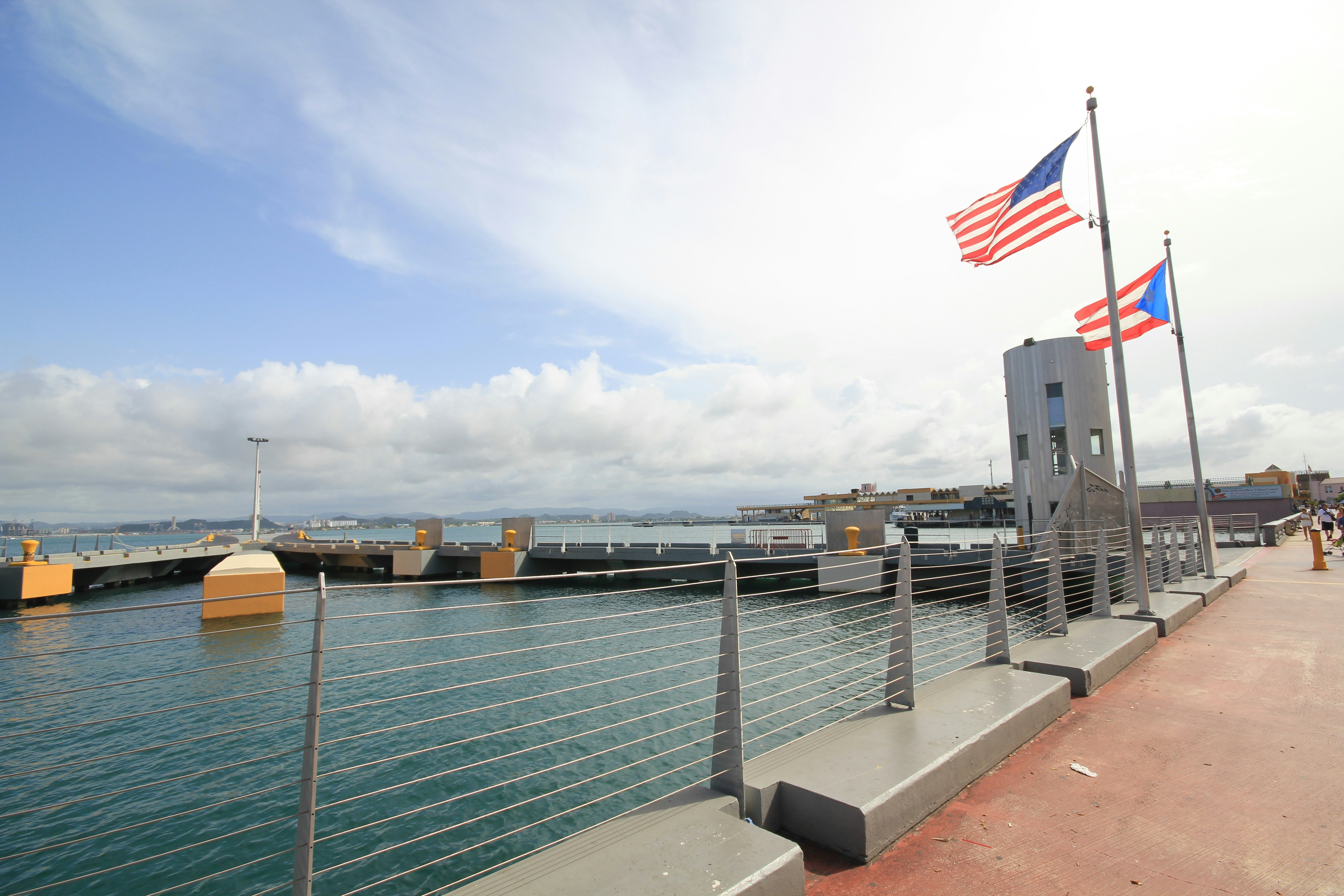 Us a flag on gray metal railings near body of water during daytime ...