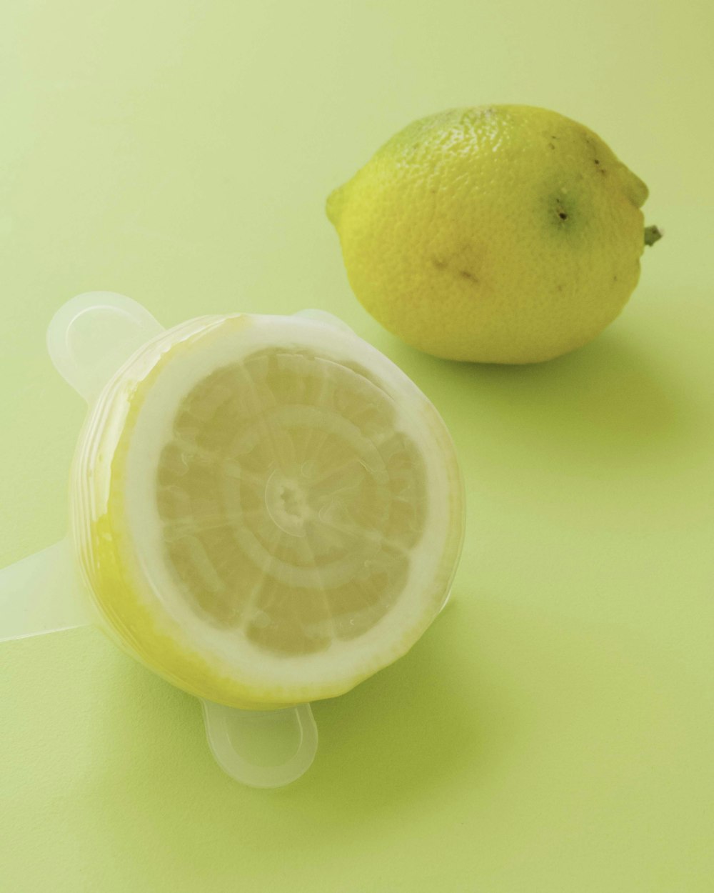 yellow lemon fruit on white surface