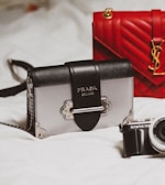 black and silver camera on white textile