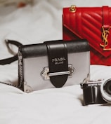 black and silver camera on white textile