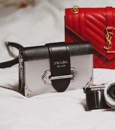 black and silver camera on white textile