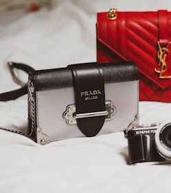 black and silver camera on white textile