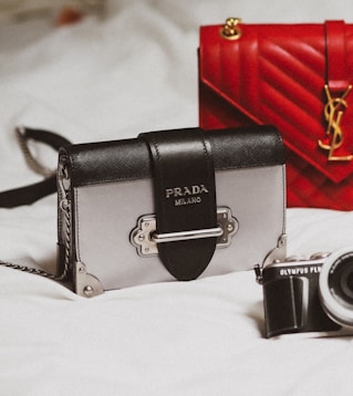 black and silver camera on white textile