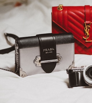 black and silver camera on white textile