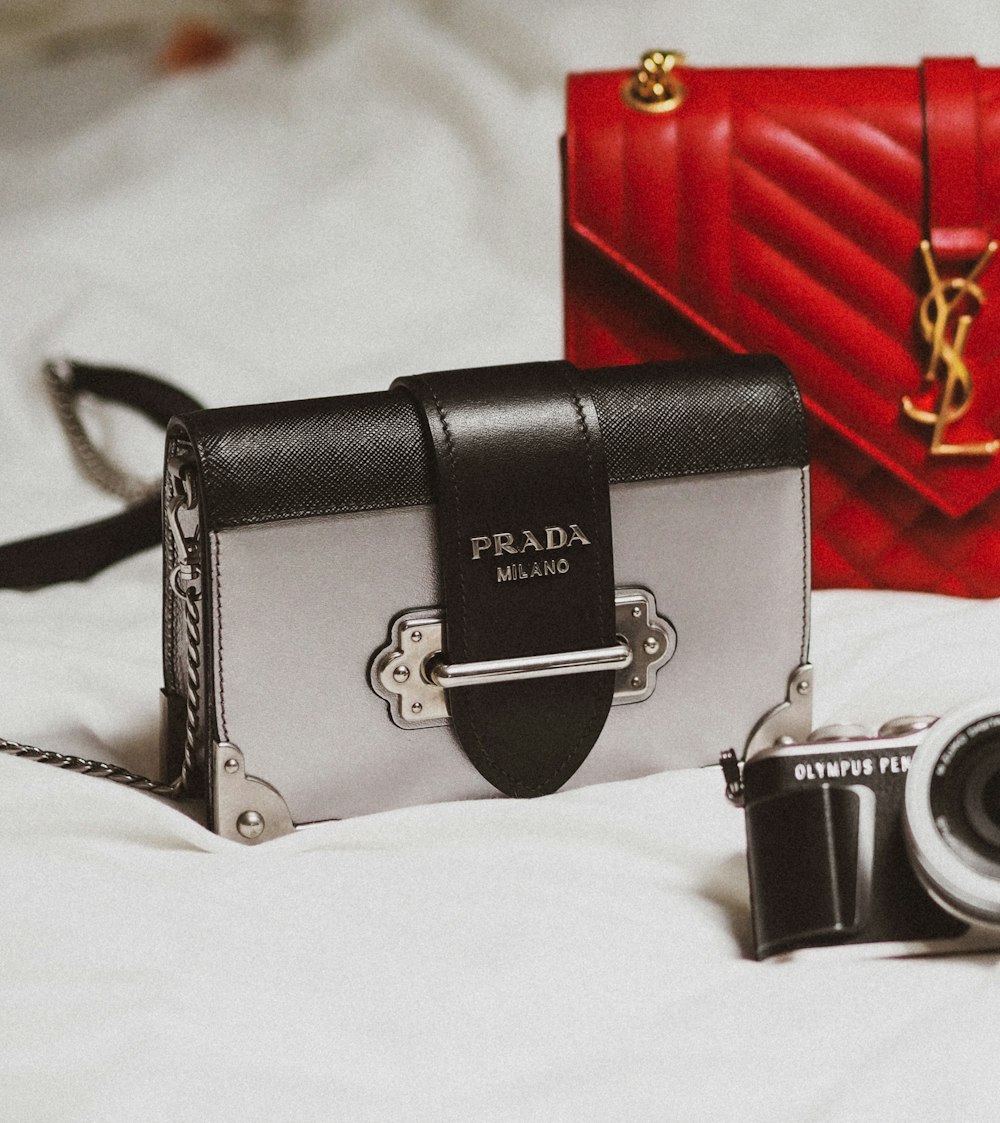 A black and gold purse sitting on top of a white couch photo – Free  Luxurious Image on Unsplash