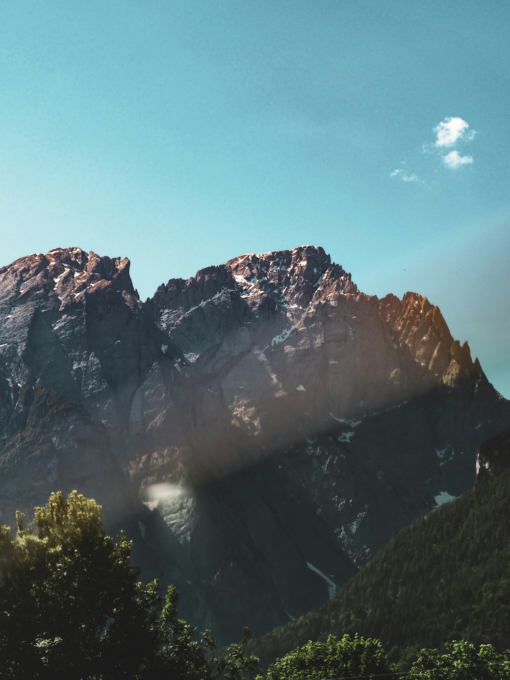 brown rocky mountain under blue sky during daytime