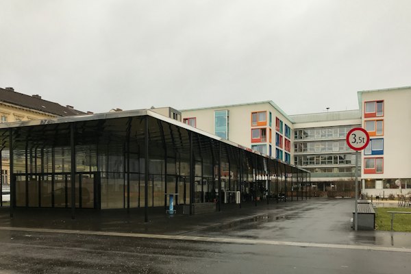 White and brown concrete building under white sky during daytime — Linz, Austria