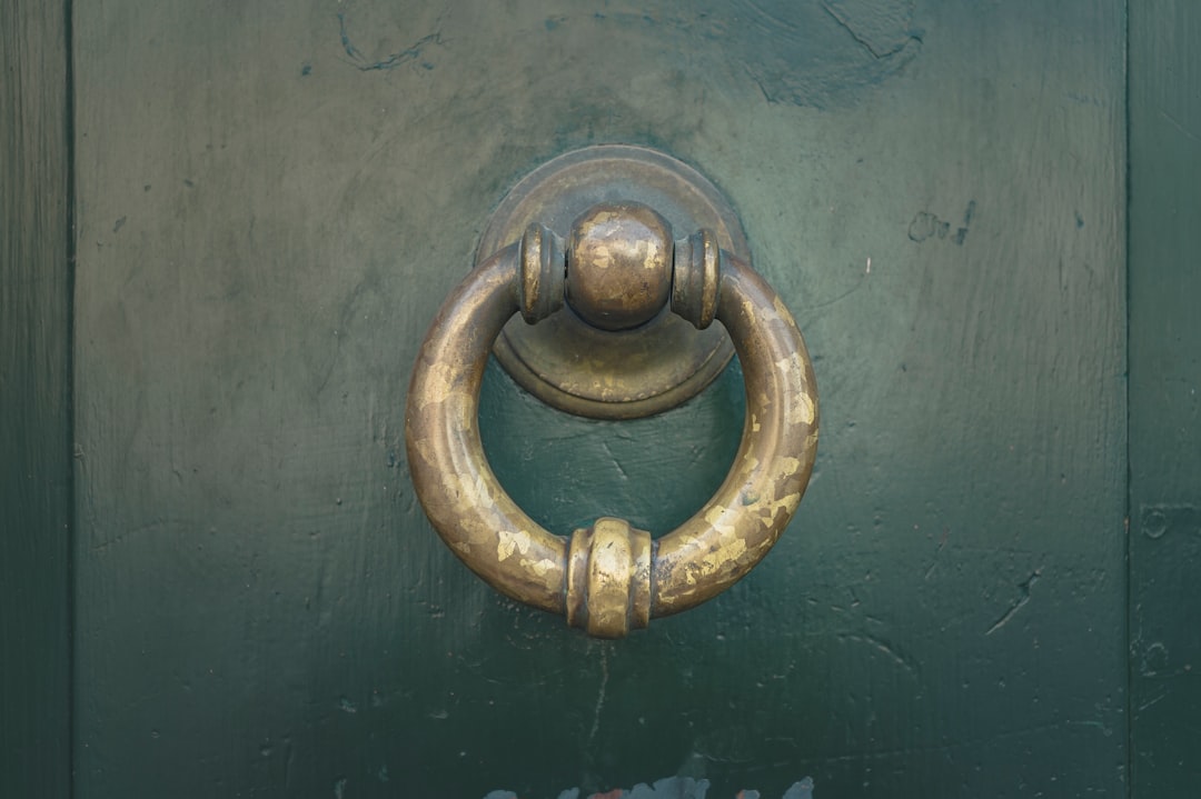 gold door knob on blue wooden door