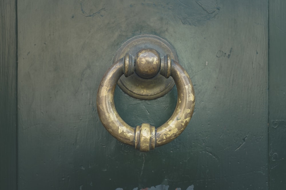 gold door knob on blue wooden door