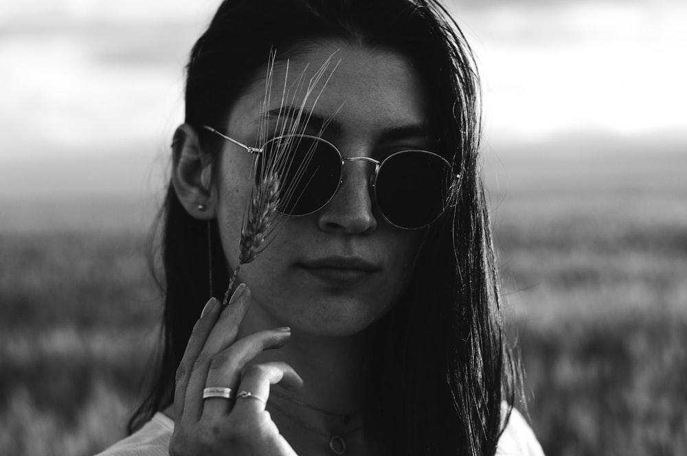 grayscale photo of woman wearing aviator sunglasses