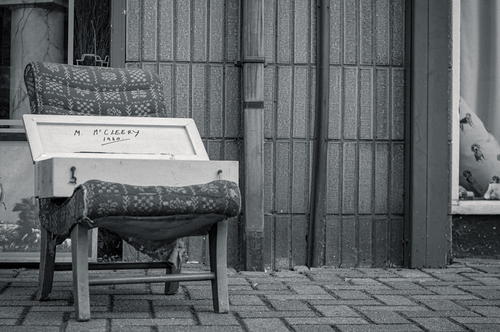 gray concrete bench beside wall