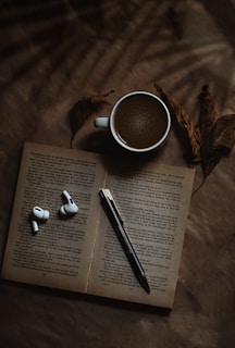 white ceramic mug on book page