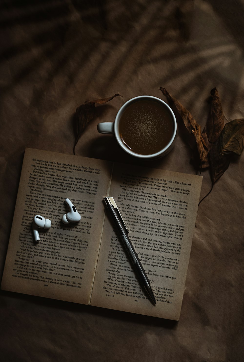 white ceramic mug on book page