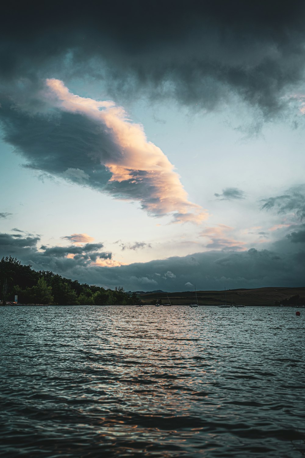 body of water under cloudy sky during daytime