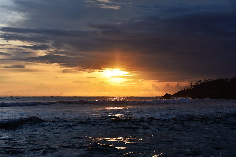 body of water during sunset