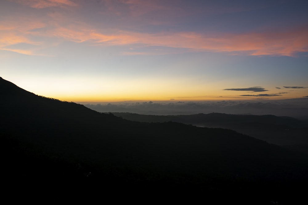 silhouette of mountains during sunset