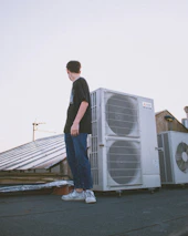 man in blue denim jeans standing on gray wooden dock during daytime