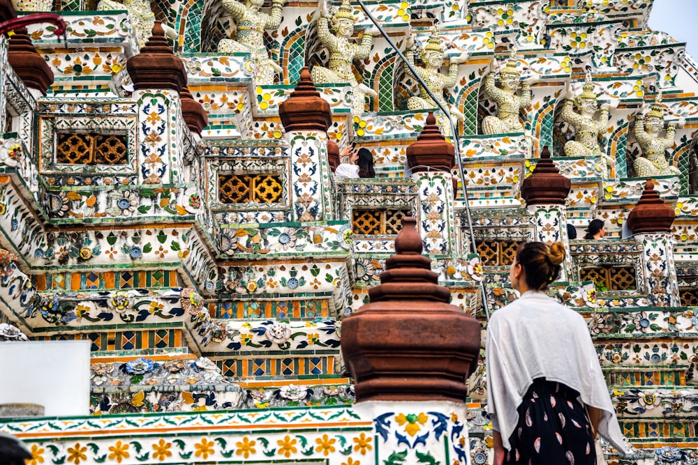 people walking on gold and white temple during daytime