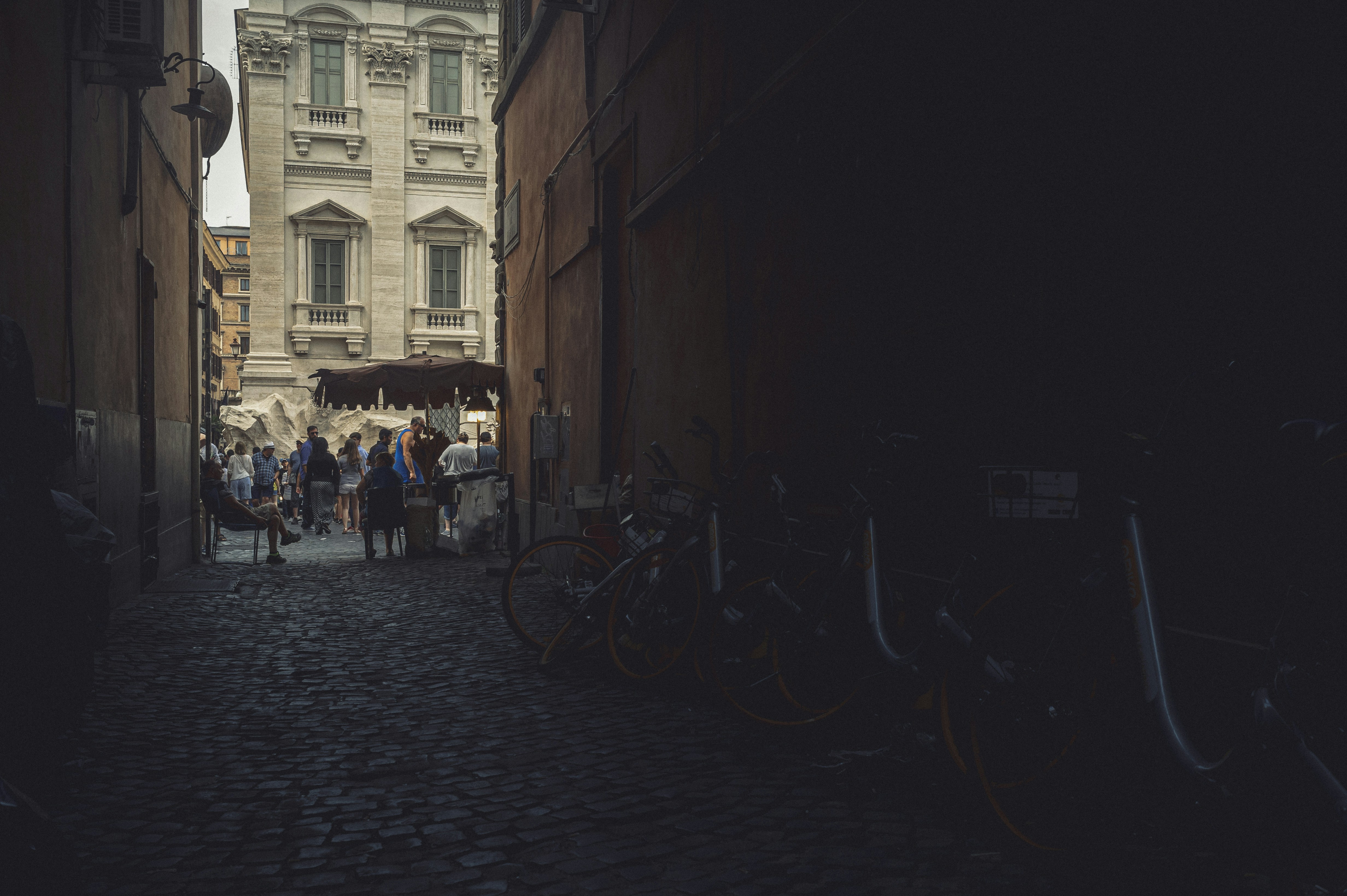 Bicycles Parked On Sidewalk Near Building During Daytime Photo Free Fontan Trevi Image On Unsplash