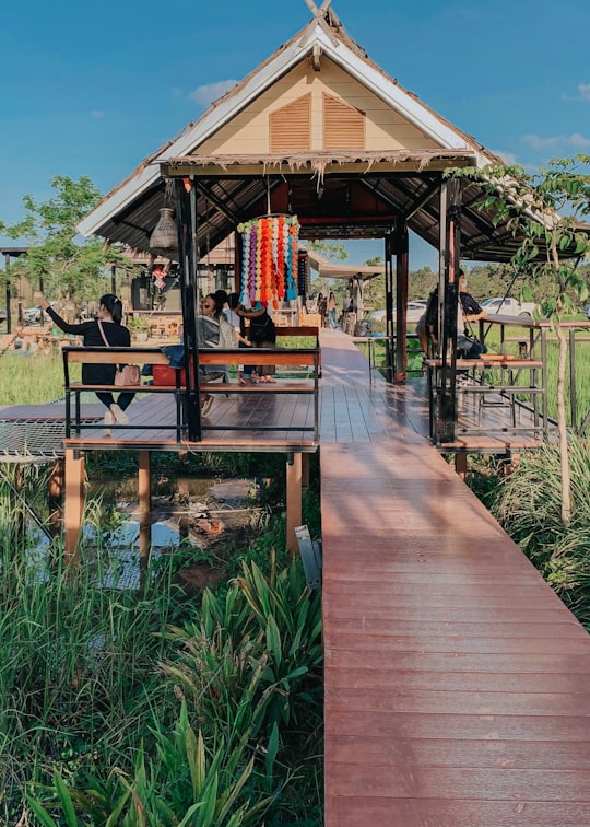 brown wooden gazebo near green plants during daytime in Buriram Thailand