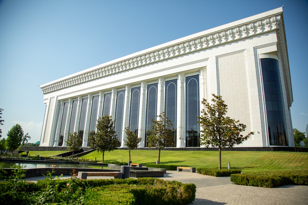 white concrete building with green grass lawn