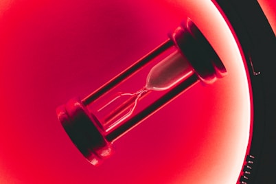 clear hour glass with red background