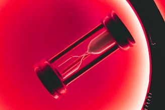 clear hour glass with red background