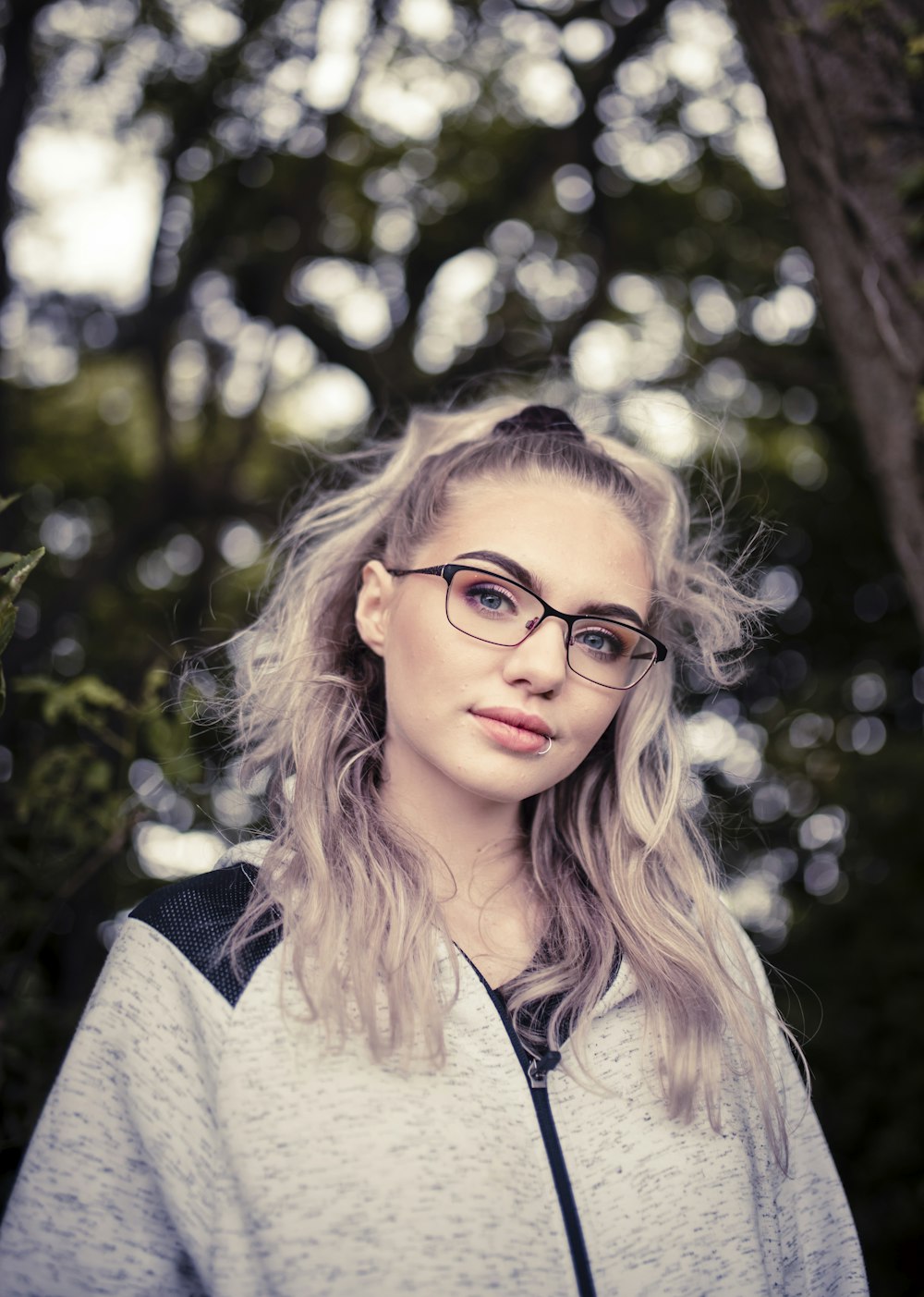 woman in white and black shirt wearing black framed eyeglasses