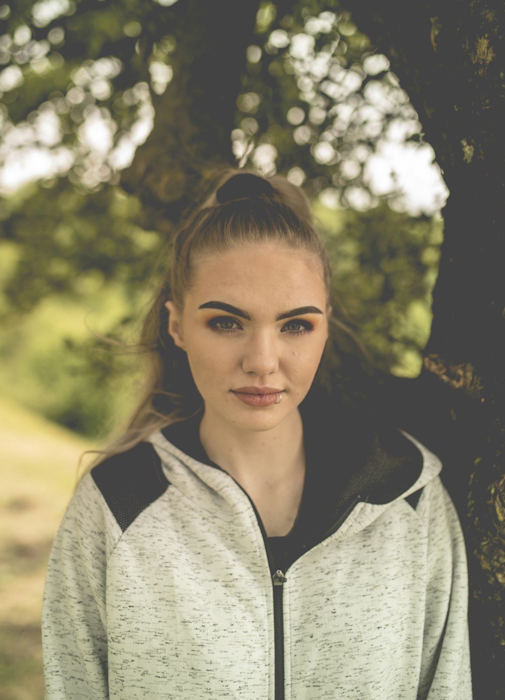 woman in gray zip up hoodie smiling